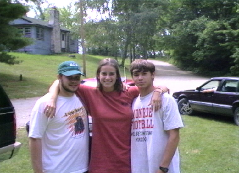 Plyc064.jpg - Geoff Horst, Ann Frisbie and Eric ”Ivy” Iverson in the parking lot at the entrance to camp.