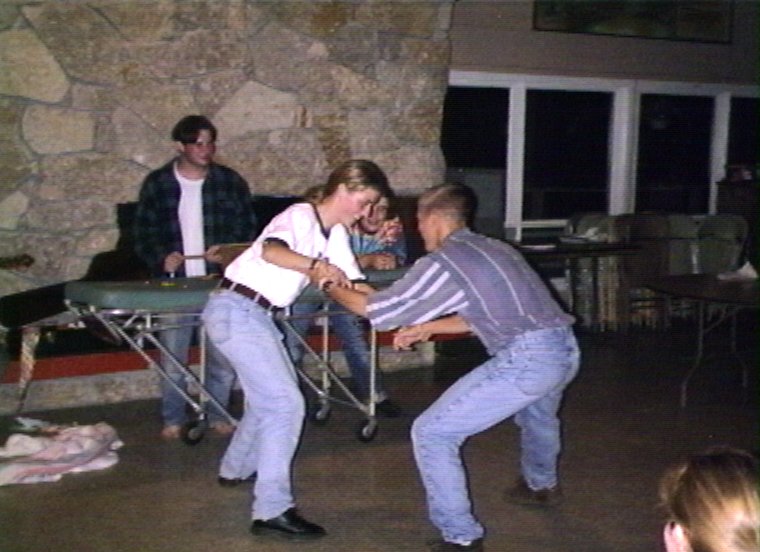 Plyc221.jpg - Staffparty in the Dinning Hall. Carrie Gasser and Jon Orum in a friendly wrestling match.
