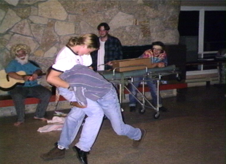 Plyc222.jpg - Staffparty in the Dinning Hall. Carrie Gasser and Jon Orum in a friendly wrestling match.